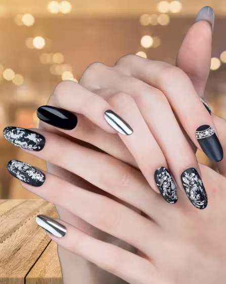 A woman's hands are gently held together, showcasing a beautiful nail design